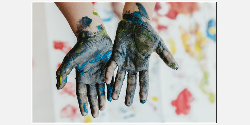 dark blue fingerpainted hands